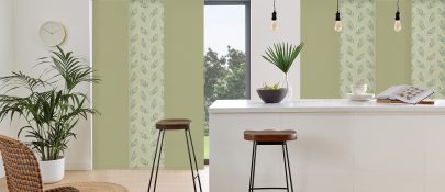 green and patterned panel blinds in kitchen area